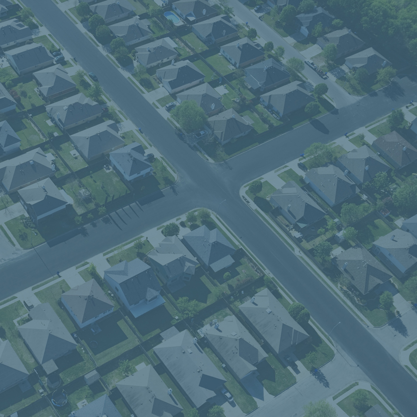 aerial view of large housing development showing homes, yards and street grid